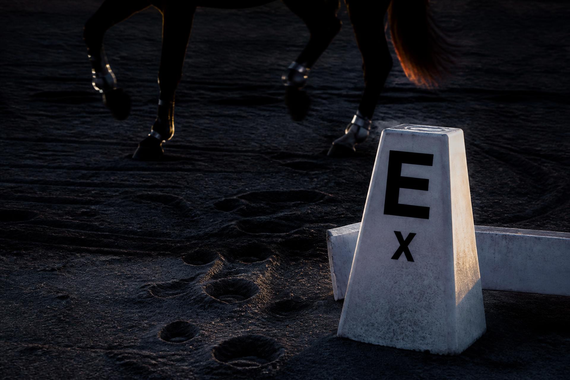 Dressage arena marker in raked sand at dusk